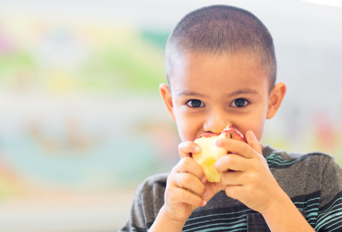Boy eating apple